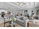 Open-concept living room with kitchen, marble floors, recessed lighting, and modern, comfortable furniture at 6605 24Th S Ave, Tampa, FL 33619