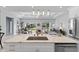 Open layout shows kitchen island with sink and seating, open to dining, living room at 6605 24Th S Ave, Tampa, FL 33619