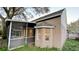 House exterior with a screened patio and a large oak tree at 7117 50Th E Ave, Palmetto, FL 34221