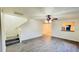 Open living room with grey laminate floors and a staircase at 7117 50Th E Ave, Palmetto, FL 34221