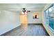 Spacious living area with grey laminate wood flooring and large windows at 7117 50Th E Ave, Palmetto, FL 34221