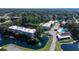 Aerial view of condo community with pool,ponds, and lush landscaping at 940 Virginia St # 208, Dunedin, FL 34698