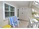 Small balcony with two chairs and a side table at 940 Virginia St # 208, Dunedin, FL 34698