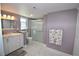 Updated bathroom with white vanity, shower and marble floors at 940 Virginia St # 208, Dunedin, FL 34698