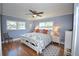 Bright bedroom with king-size bed, hardwood floors, and ceiling fan at 940 Virginia St # 208, Dunedin, FL 34698