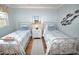 Guest bedroom with twin beds and coastal decor at 940 Virginia St # 208, Dunedin, FL 34698