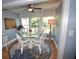 Cozy dining area with glass-top table and white chairs at 940 Virginia St # 208, Dunedin, FL 34698