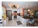 Modern kitchen with stainless steel appliances and breakfast bar at 940 Virginia St # 208, Dunedin, FL 34698