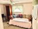 Small bedroom with daybed and wood floors at 9790 66Th N St # 33, Pinellas Park, FL 33782
