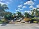 Community entrance with a landscaped fountain and palm trees at 9790 66Th N St # 33, Pinellas Park, FL 33782