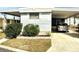 Mobile home with carport and landscaped yard at 9790 66Th N St # 33, Pinellas Park, FL 33782