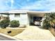 Mobile home with carport and a car parked in the driveway at 9790 66Th N St # 33, Pinellas Park, FL 33782