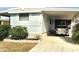 Mobile home with carport and a car parked in the driveway at 9790 66Th N St # 33, Pinellas Park, FL 33782