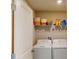 Laundry room with washer, dryer, and storage shelves at 993 Anchor Bend Dr, Ruskin, FL 33570