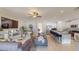 Open concept living room features a modern sofa and flows into the kitchen at 993 Anchor Bend Dr, Ruskin, FL 33570