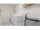 Bright laundry room with washer, dryer, and shelving at 10108 Newel Valley Loop, Riverview, FL 33569