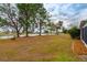 Spacious backyard with pond view and lush trees at 1015 El Rancho Dr, Sun City Center, FL 33573