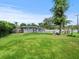 Large backyard with grassy lawn, pool, and playset at 10603 Coquita Ln, Tampa, FL 33618