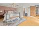 Main bedroom with brick accent wall, wood floors, and barn door at 10603 Coquita Ln, Tampa, FL 33618