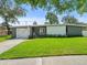 Charming ranch home with updated exterior and well-manicured lawn at 10603 Coquita Ln, Tampa, FL 33618