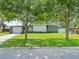Ranch style home with attached garage and manicured lawn at 10603 Coquita Ln, Tampa, FL 33618