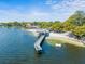 Aerial view of lake access with pier and sandy beach at 10603 Coquita Ln, Tampa, FL 33618