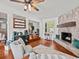 Living room features a stone fireplace, built-in shelving and hardwood floors at 10603 Coquita Ln, Tampa, FL 33618