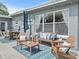 Inviting patio with seating area, umbrella, and patterned tile floor at 10603 Coquita Ln, Tampa, FL 33618