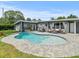 Relaxing kidney-shaped pool with spacious patio area at 10603 Coquita Ln, Tampa, FL 33618