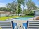 Inviting kidney-shaped pool with brick patio and lounge chairs at 10603 Coquita Ln, Tampa, FL 33618