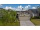 Single-story house with a two-car garage and a neatly landscaped yard at 11607 Branch Mooring Dr, Tampa, FL 33635