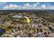 Aerial view showing the house's location in a residential neighborhood near a lake at 11607 Branch Mooring Dr, Tampa, FL 33635