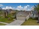 Single-story house with a two-car garage, solar panels, and lush landscaping at 11607 Branch Mooring Dr, Tampa, FL 33635