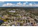 Wide aerial view of the house and surrounding neighborhood near a lake at 11607 Branch Mooring Dr, Tampa, FL 33635