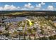 Aerial view highlighting the house's location in a residential neighborhood near a lake at 11607 Branch Mooring Dr, Tampa, FL 33635