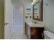 Bathroom with toilet, vanity, and access to another room at 11607 Branch Mooring Dr, Tampa, FL 33635