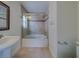 Bathroom with tub, shower, and pedestal sink at 11607 Branch Mooring Dr, Tampa, FL 33635