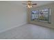 Bedroom with large window overlooking backyard at 11607 Branch Mooring Dr, Tampa, FL 33635