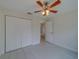 Bright bedroom with ceiling fan and double door closet at 11607 Branch Mooring Dr, Tampa, FL 33635