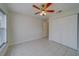 Bedroom with tile floors, ceiling fan, and double door closet at 11607 Branch Mooring Dr, Tampa, FL 33635