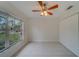 Bedroom with large window, tile floors, and ceiling fan at 11607 Branch Mooring Dr, Tampa, FL 33635