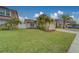 House with a two-car garage, palm trees, and a well-maintained lawn at 11607 Branch Mooring Dr, Tampa, FL 33635