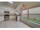Eat-in kitchen with white cabinets, granite counters, and stainless steel appliances at 11607 Branch Mooring Dr, Tampa, FL 33635