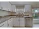 Kitchen features granite countertops, white cabinets and stainless steel appliances at 11607 Branch Mooring Dr, Tampa, FL 33635