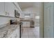 Updated kitchen featuring white cabinets, granite countertops, and stainless steel appliances at 11607 Branch Mooring Dr, Tampa, FL 33635