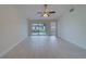 Spacious living area featuring tile floors and access to the backyard patio at 11607 Branch Mooring Dr, Tampa, FL 33635