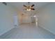 Open living room with tile flooring and access to other rooms at 11607 Branch Mooring Dr, Tampa, FL 33635