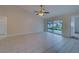 Living room with tile floors, sliding glass doors, and backyard access at 11607 Branch Mooring Dr, Tampa, FL 33635
