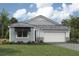 One-story home with gray siding, white garage door, and landscaping at 11683 Rose Gold Ct, Venice, FL 34293