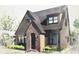 Gray craftsman home with brick accents and a charming front porch at 1212 E Comanche Ave, Tampa, FL 33604